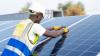 A man fixing a solar panel